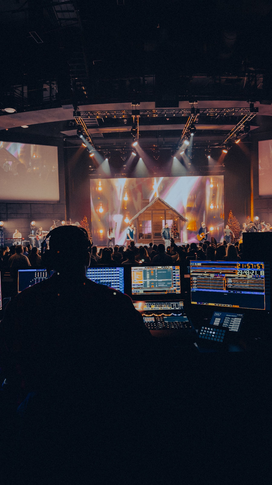 Travis Hughes programming a GrandMA3 lighting console during a live show